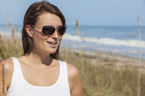 Woman in White Dress and Sunglasses At Beach