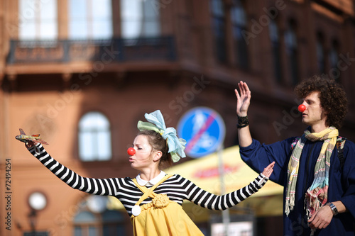 Fotografie Clowns playing with plane, sad clown seeing off