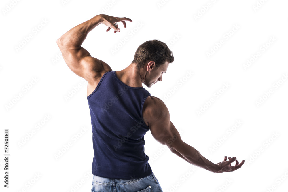 Back of attractive bodybuilder in t-shirt and jeans