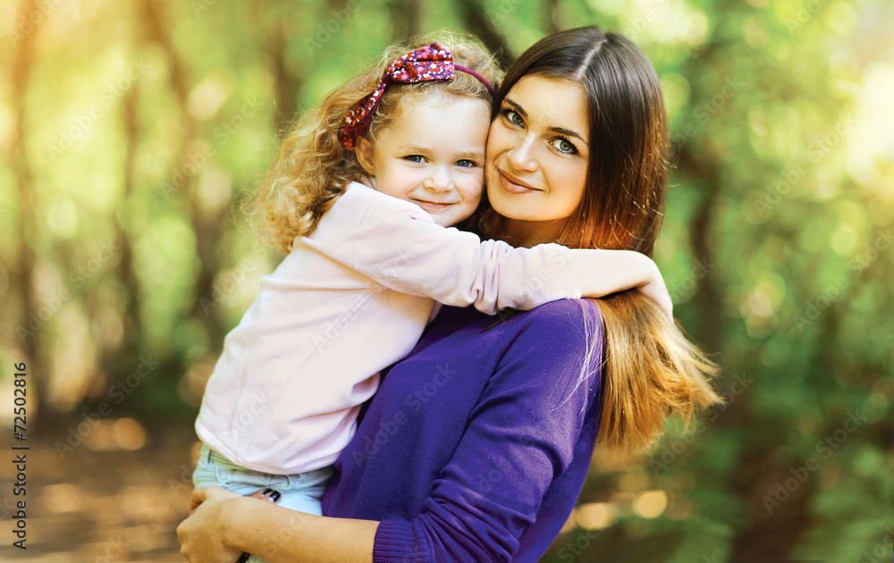 Fototapeta premium Lovely mother and child walking in the park outdoors
