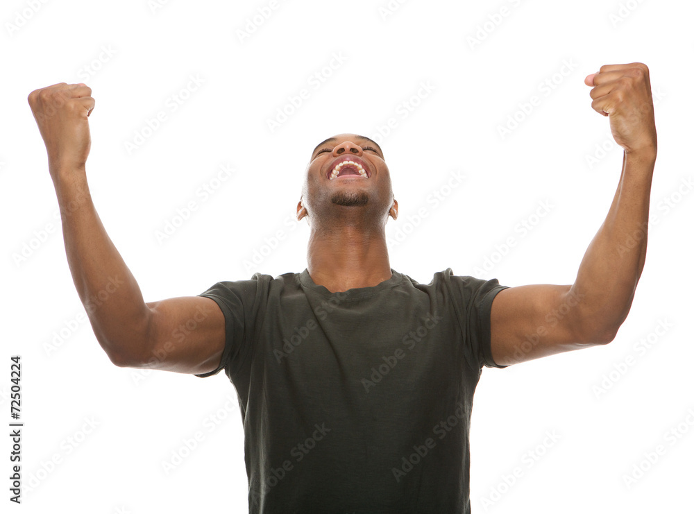 Cheerful young man shouting with arms raised in success Cheerful young man shouting with arms raised in success