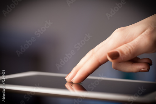 Finger pointing on tablet pc with empty space