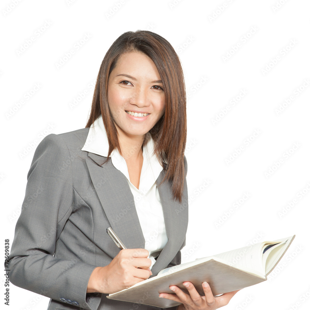 Business woman asian attractive standing using a pen writing dia Business woman asian attractive standing using a pen writing dia
