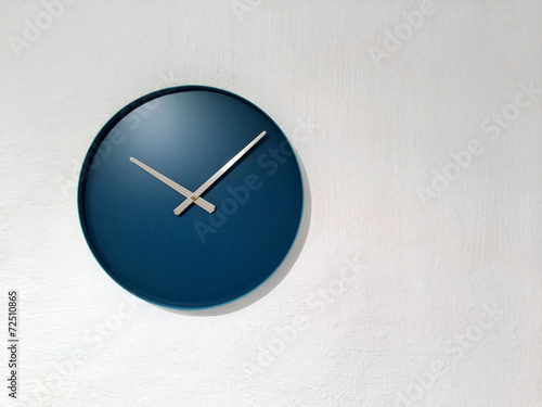 Blue clock on white wall