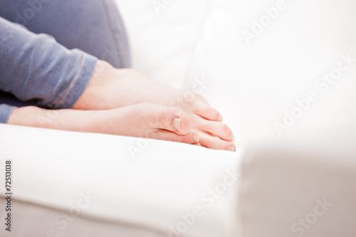 feet of a young woman sleeping on a couch