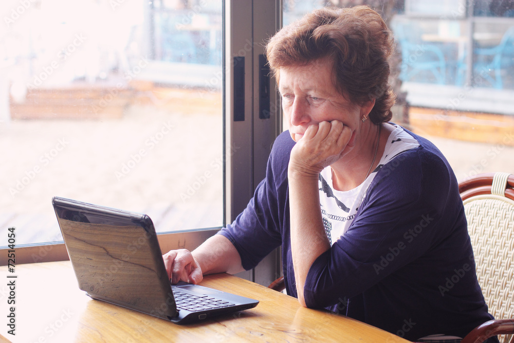 senior woman sitting on the cafe with laptop senior woman sitting on the cafe with laptop