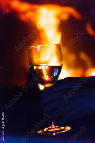 glass of wine beside the fire