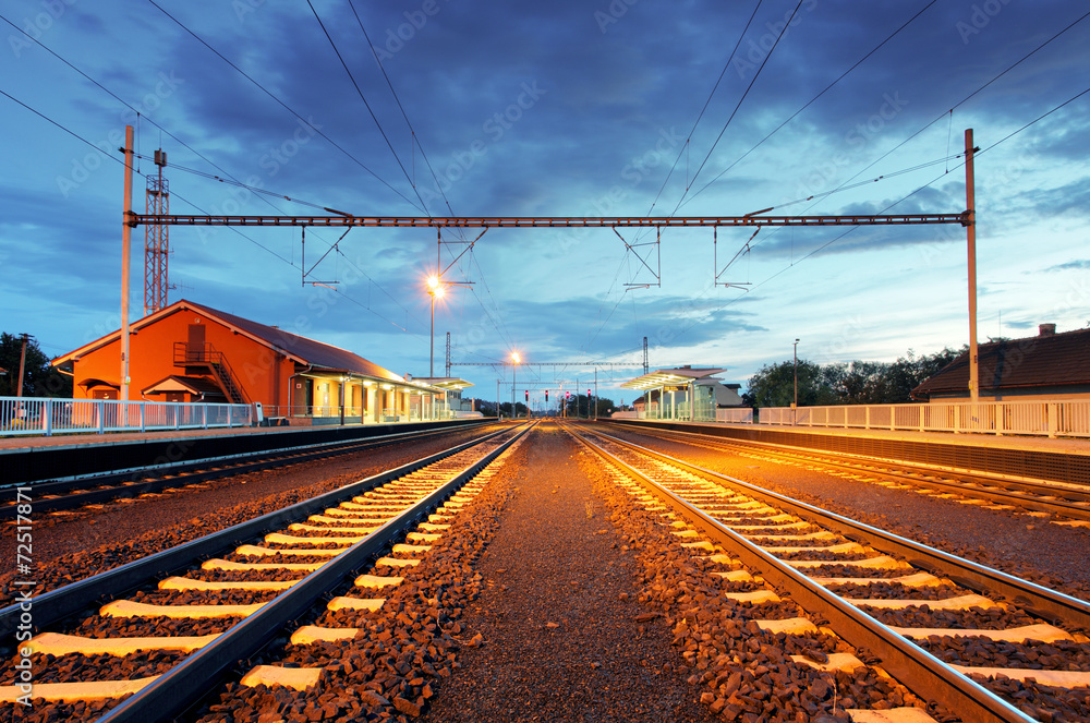 Fototapeta premium Train station in motion blur at night, railroad