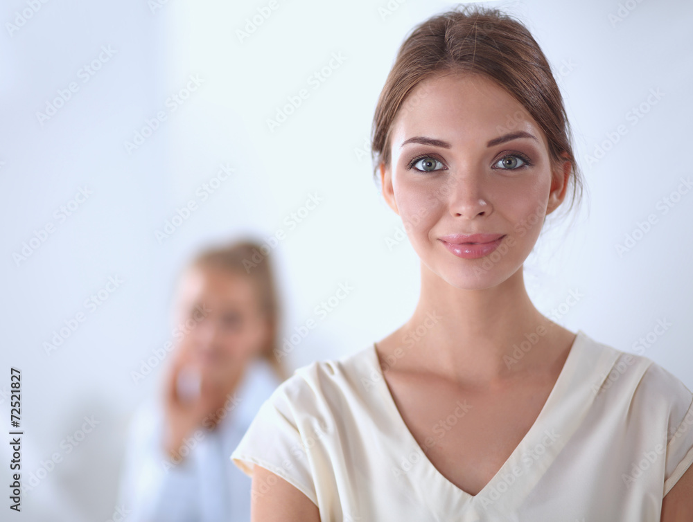 Attractive young businesswoman standing near desk in office Attractive young businesswoman standing near desk in office