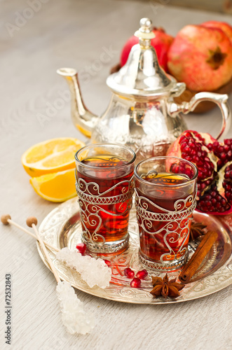 Traditional arabic tea with metal teapot and glasses vertical