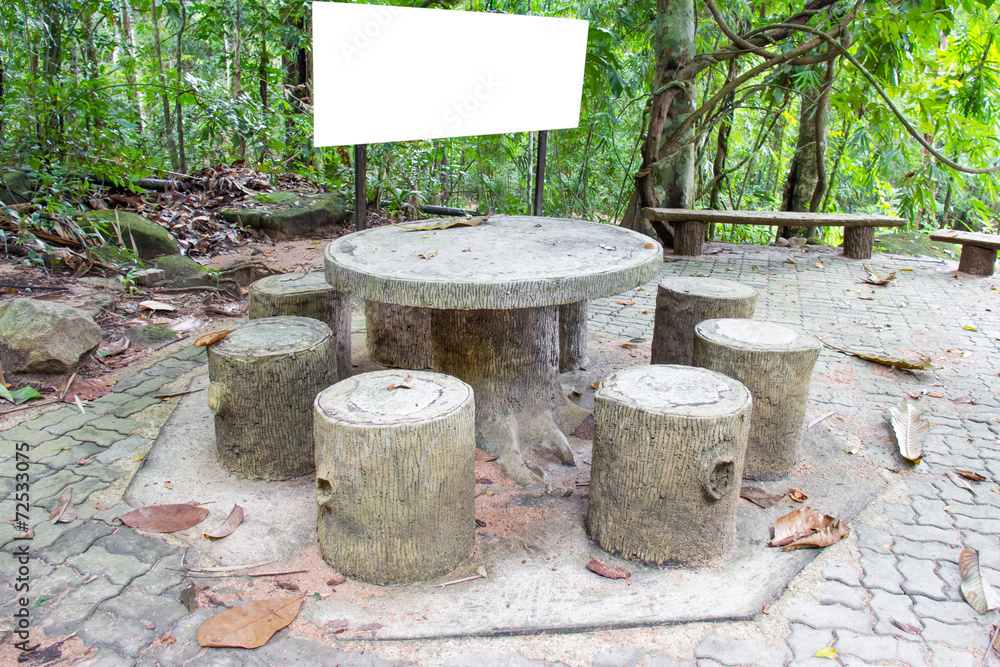 Set of table and chairs with blank billboard in jungle Set of table and chairs with blank billboard in jungle