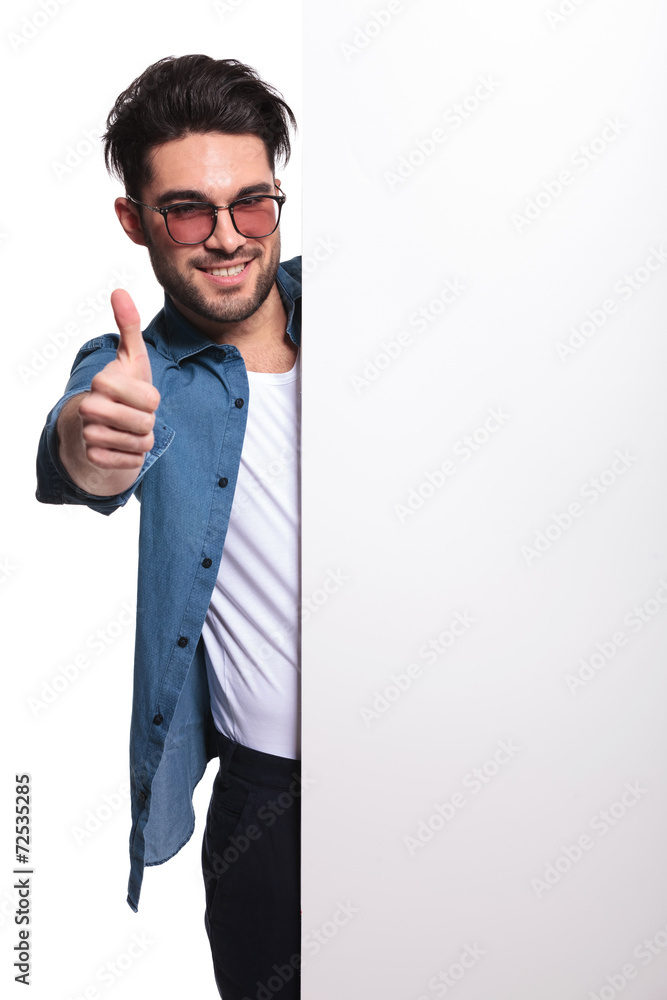 Young casual man presenting a white board Young casual man presenting a white board