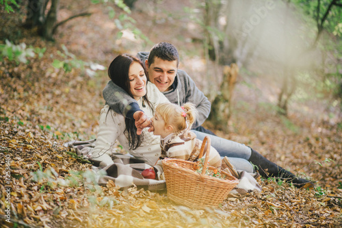 Happy family in an autumn forest