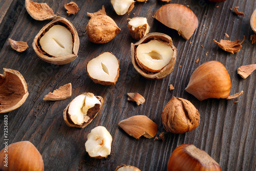 Split nuts on a wooden background
