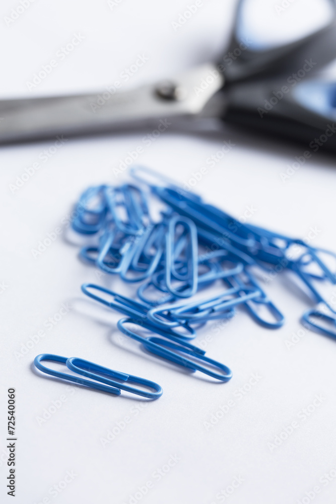 a collection of paperclips on a white surface a collection of paperclips on a white surface