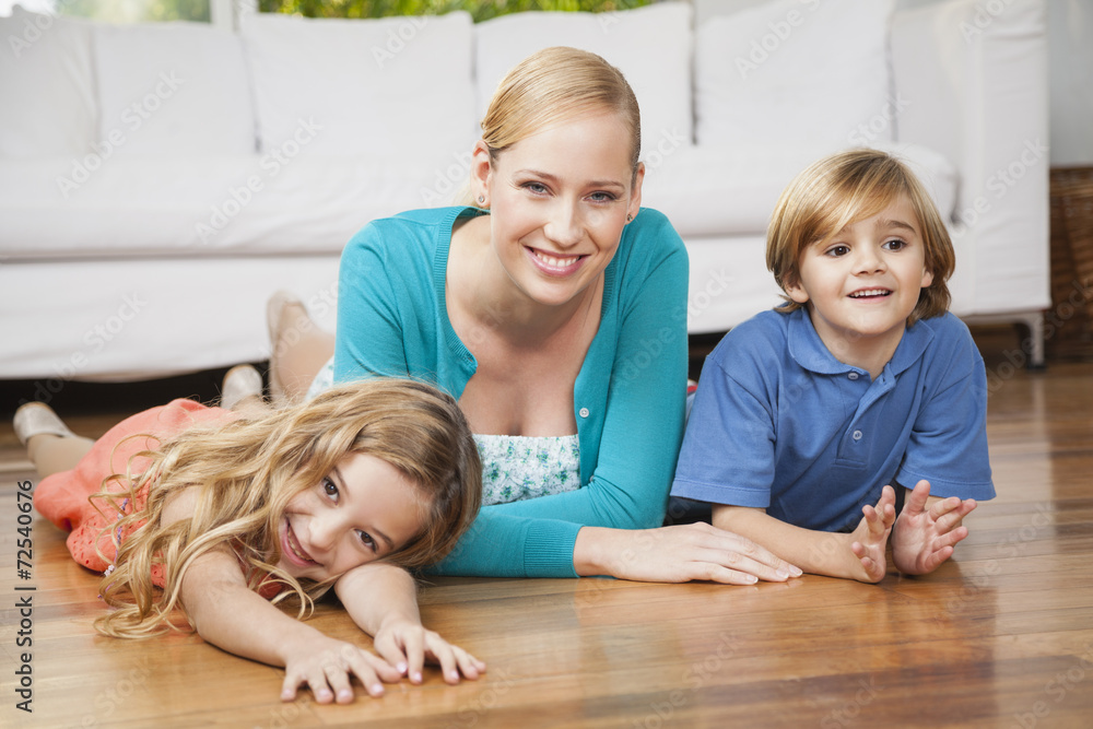 Happy family lying on floor in living room Happy family lying on floor in living room