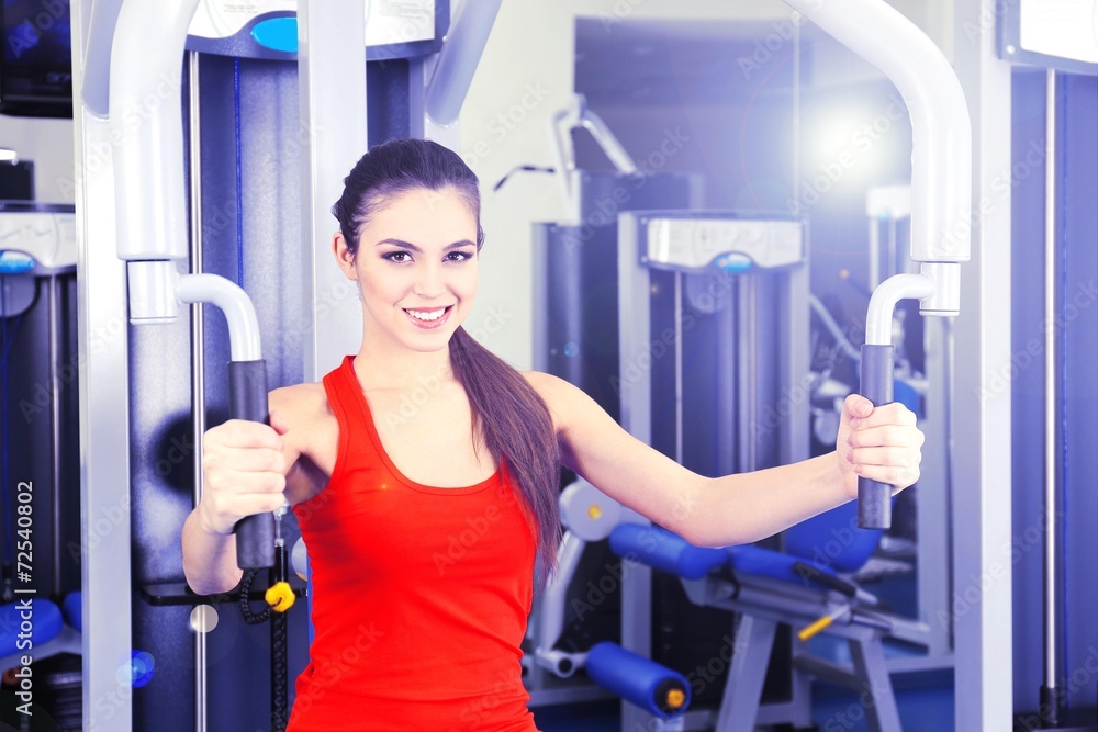 Beautiful woman training with weights in gym Beautiful woman training with weights in gym