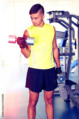 Guy with dumbbells in gym
