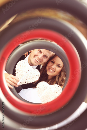 Bride and groom inside circle with white hearts