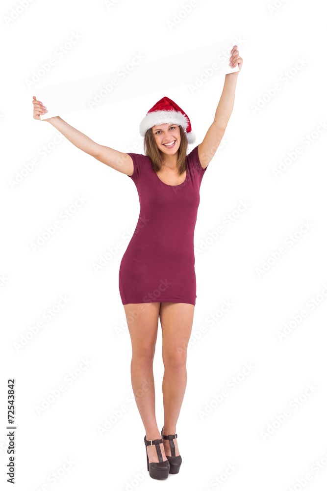 Girl standing upright while holding a poster above her head