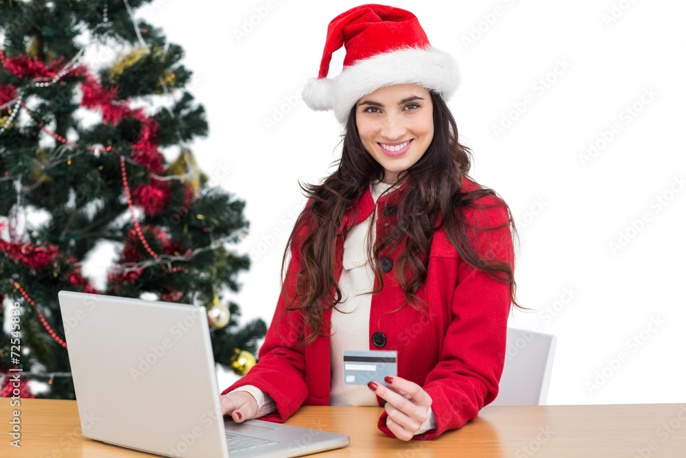 Festive brunette shopping online with laptop Festive brunette shopping online with laptop