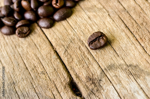coffee grains on grunge wooden background