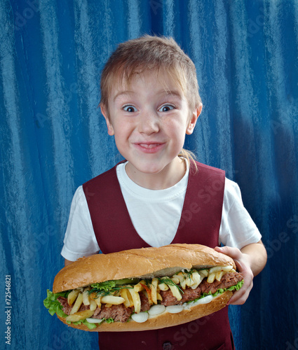 Boy eating big sandwiches photo