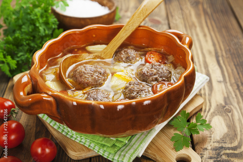 Cabbage soup with meatballs and tomatoes photo