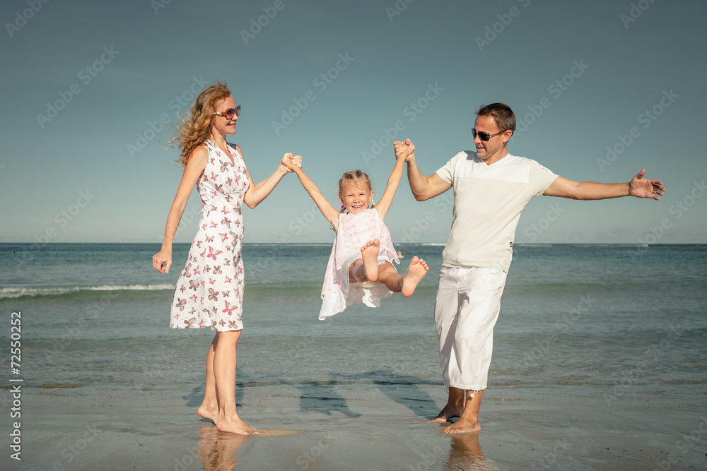 Happy family playing at the beach at the day time Happy family playing at the beach at the day time