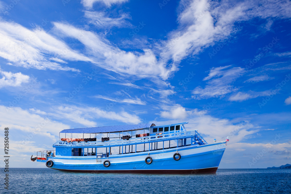 passenger wooden boat floating on blue sea water with beautiful passenger wooden boat floating on blue sea water with beautiful