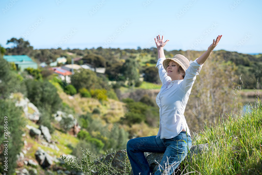 Woman in nature with arms outstretched Woman in nature with arms outstretched