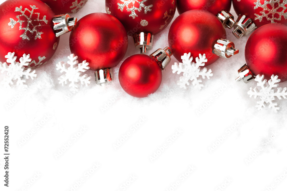 red christmas balls in the snow on white red christmas balls in the snow on white