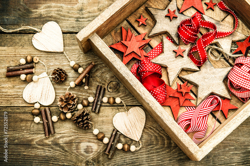 christmas decorations wooden stars and red ribbons. retro style photo