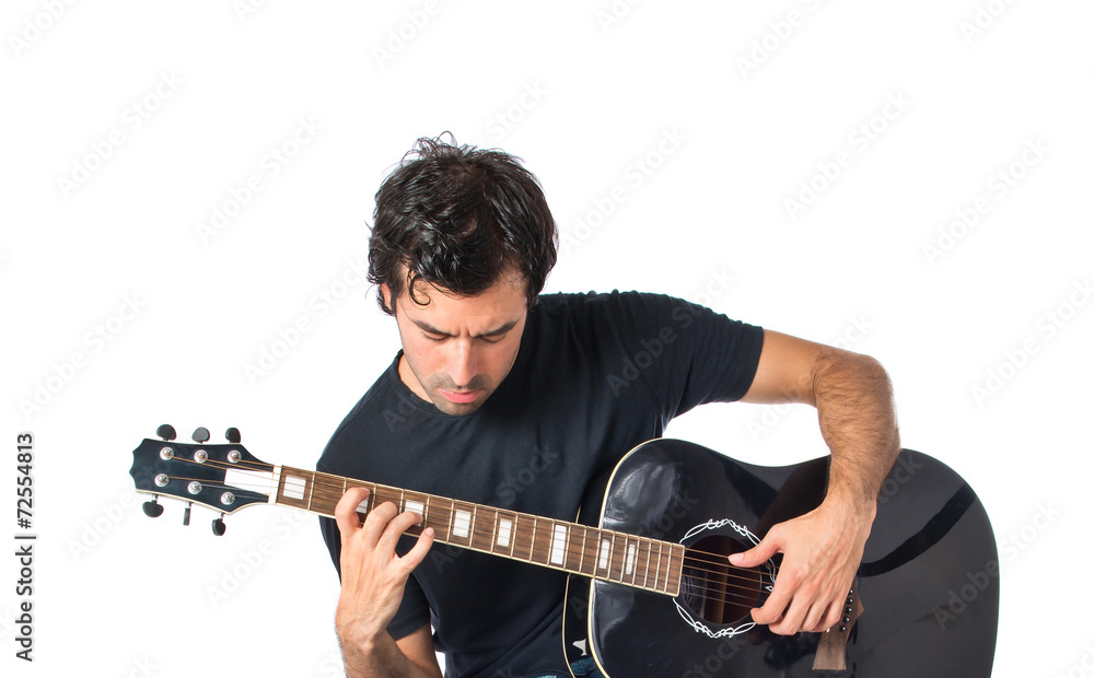 Obraz premium Handsome man with guitar over white background