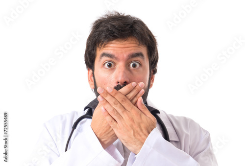 Doctor doing surprise gesture over white background