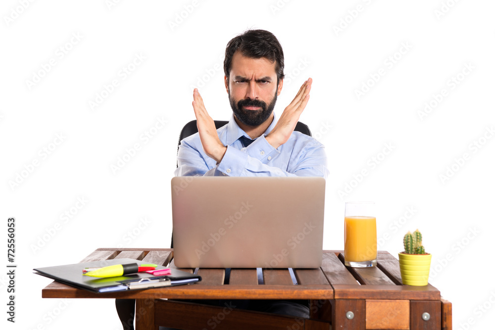 Businessman in his office making stop sign Businessman in his office making stop sign