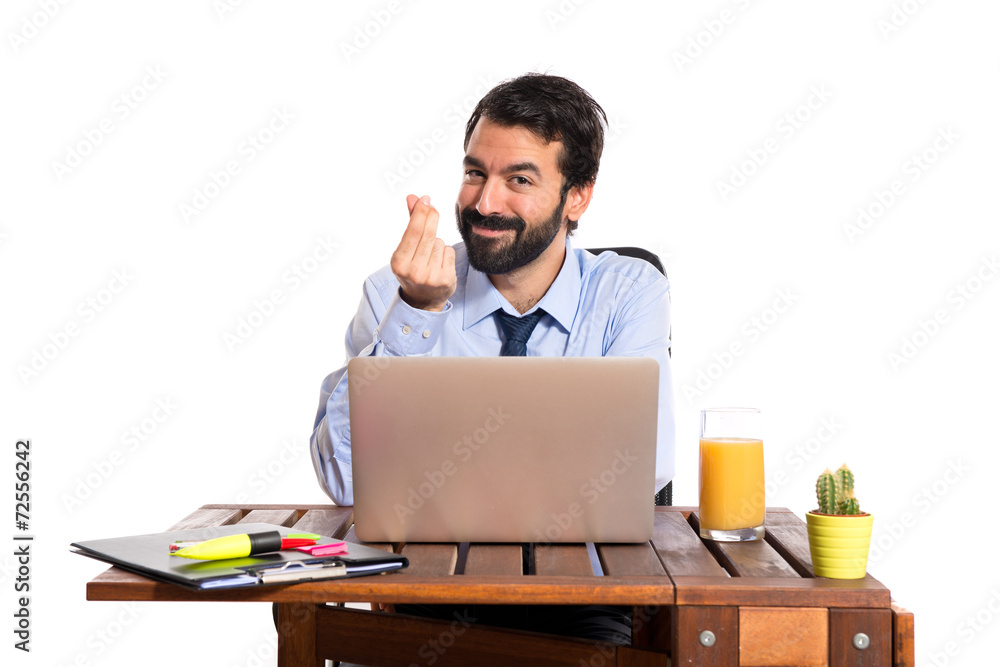 Businessman in his office doing money gesture Businessman in his office doing money gesture