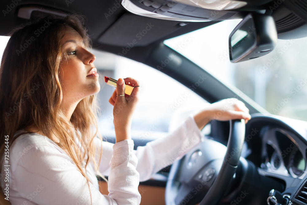 Woman applying make-up while driving Woman applying make-up while driving
