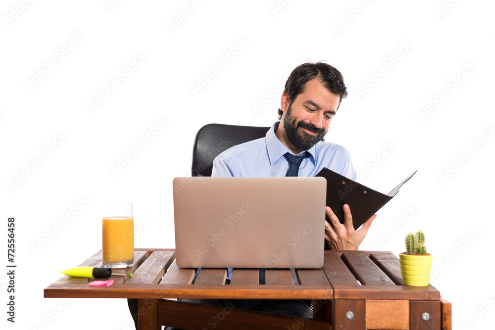 Businessman in his office with his folder Businessman in his office with his folder