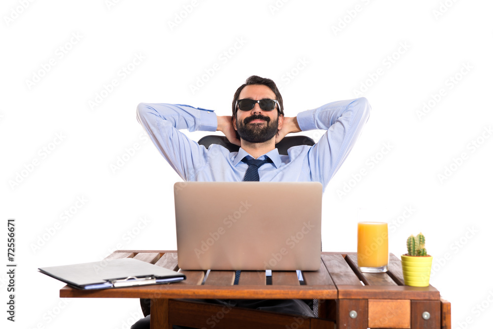 Businessman in his office with sunglasses