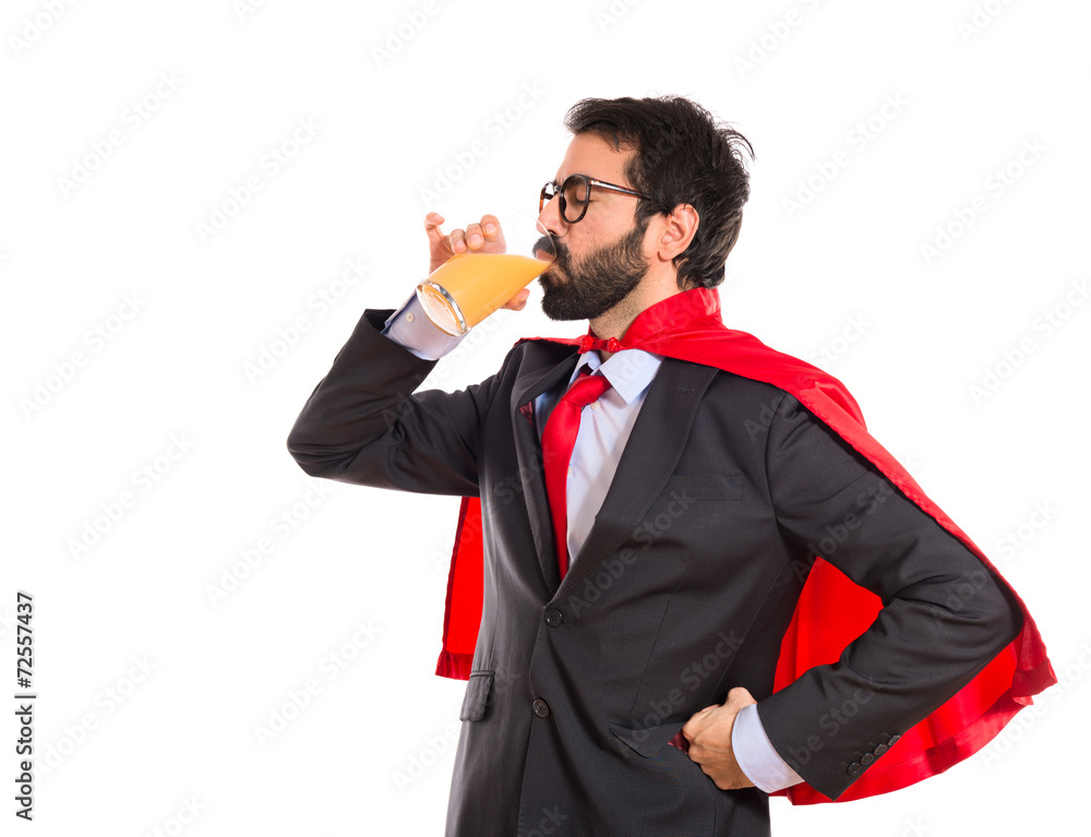 Hipster businessman dressed like superhero drinking orange juice Hipster businessman dressed like superhero drinking orange juice