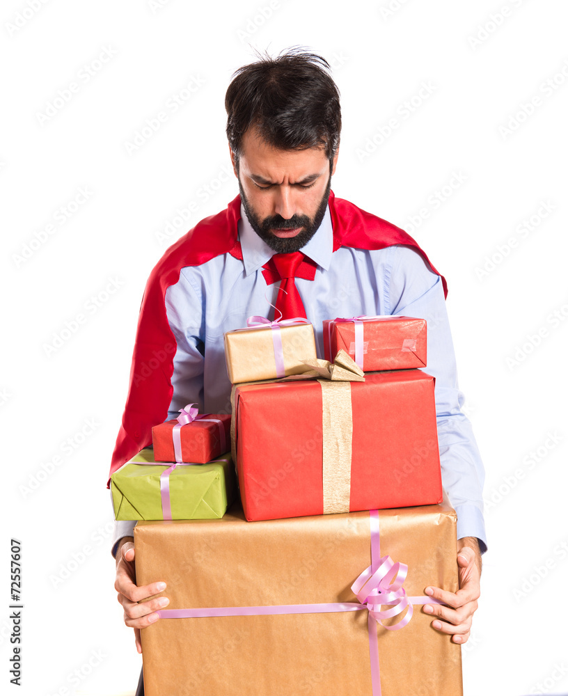 Businessman dressed like superhero holding gifts Businessman dressed like superhero holding gifts
