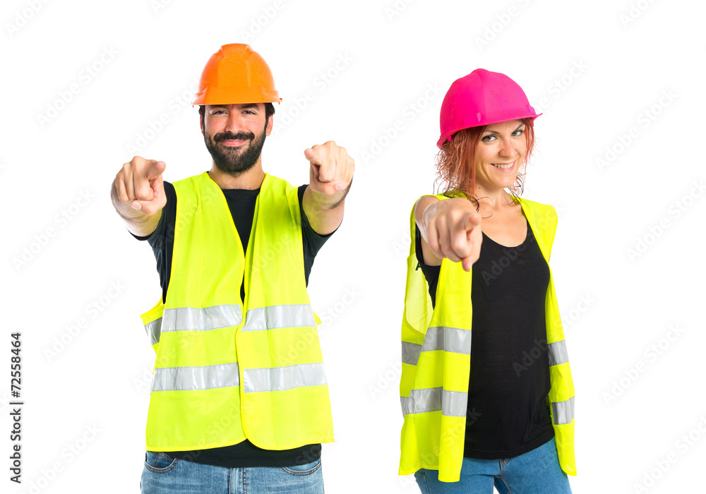 Workman pointing to the front over white background Workman pointing to the front over white background
