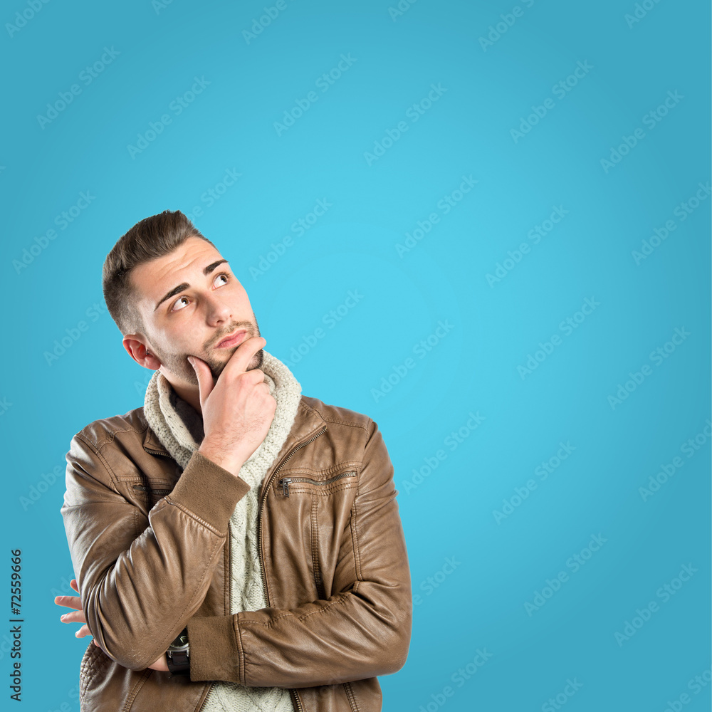 Man thinking over blue background Man thinking over blue background