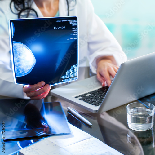 Fotografie Doctor reviewing mammogram on x-ray.