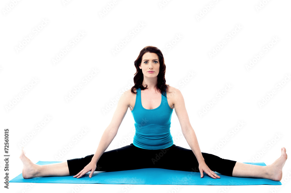 Fototapeta premium Pretty young woman doing stretching exercises