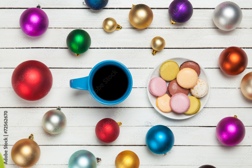 Cup of coffee and macaron with christmas toys on whte background
