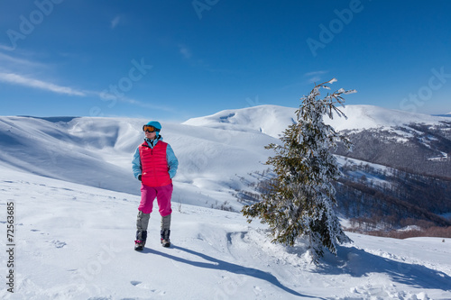 Hiker in winter mountains during sunny day