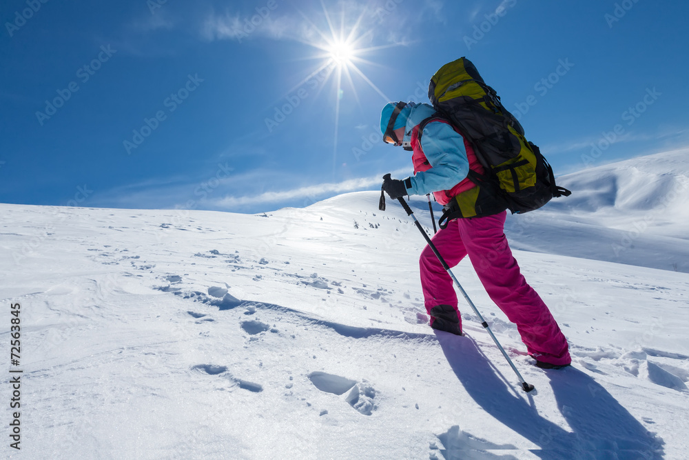 Hiker in winter mountains on sunny day Hiker in winter mountains on sunny day