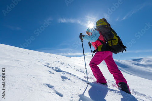 Hiker in winter mountains during sunny day